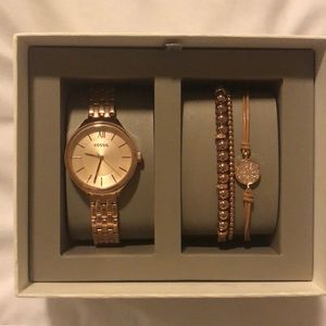 Rose gold watch with matching bracelets.